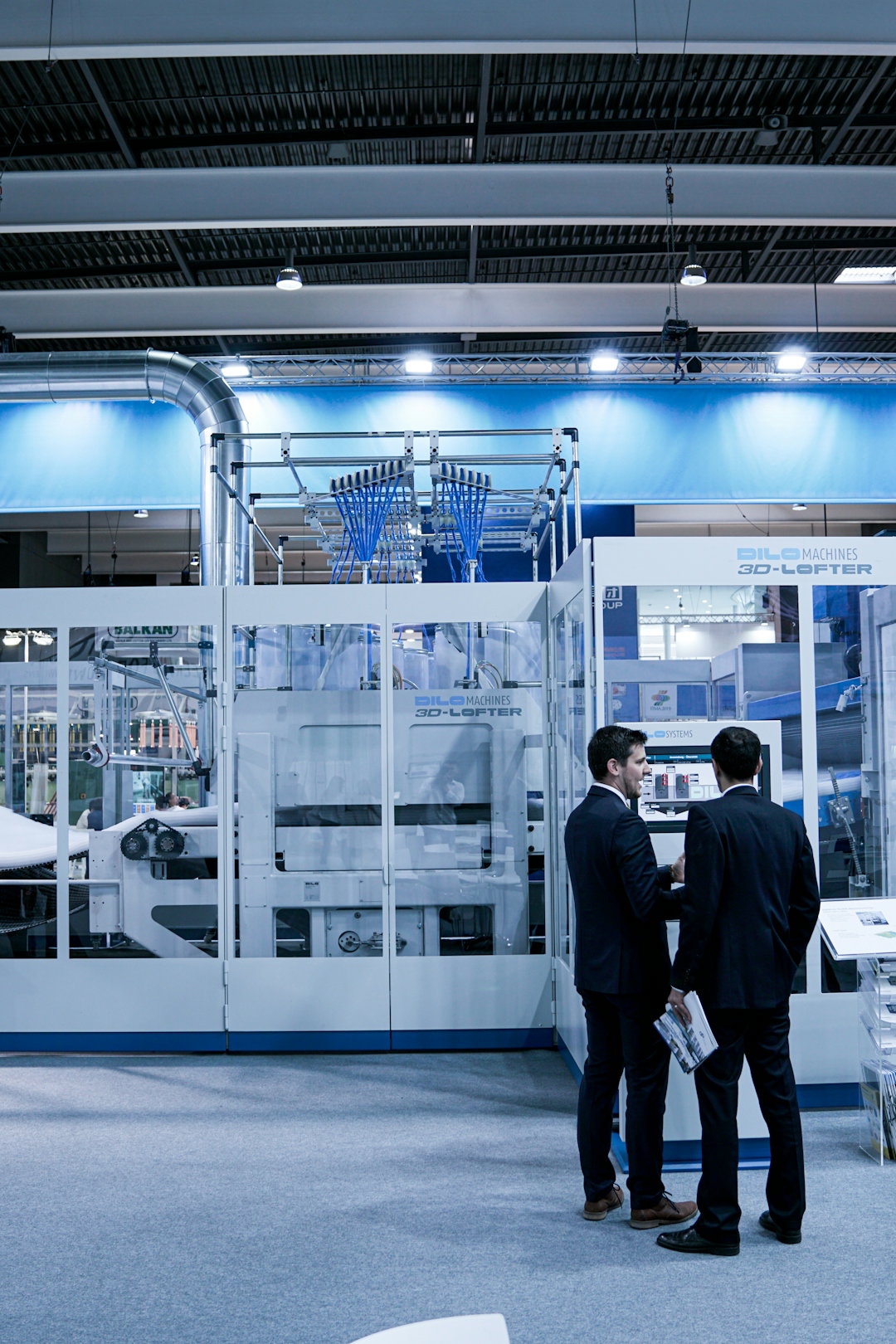 two-men-standing-in-front-of-glass-wall.jpg two men standing in front of glass wall